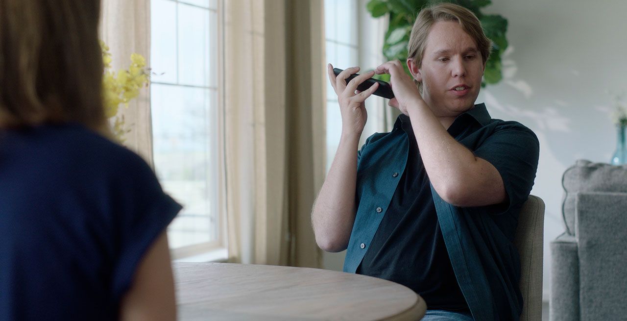 Sight impaired man holding his mobile device for audio