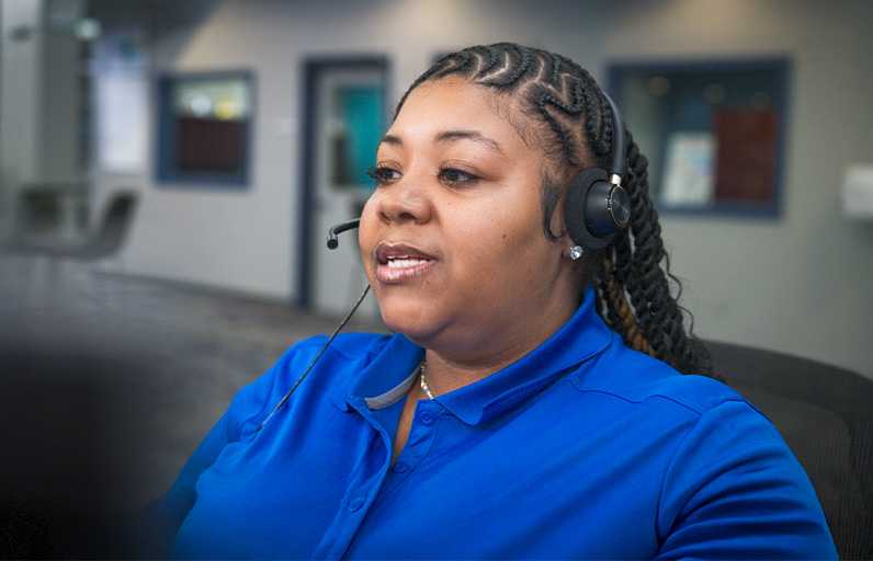 A Spectrum customer service rep smiling in a call center