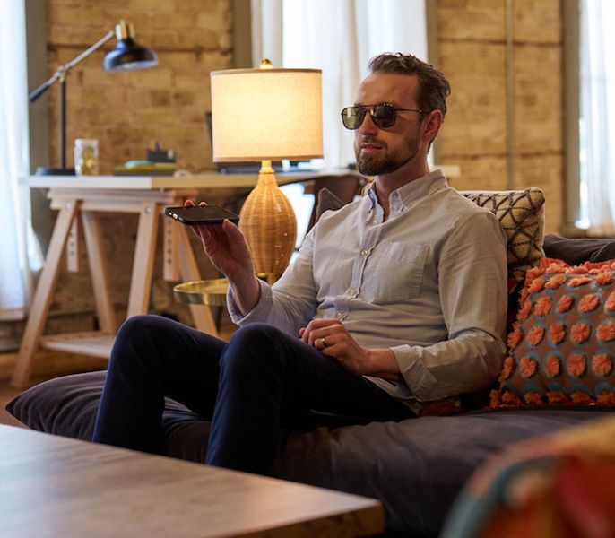 A sight impaired person using their phone for audio description