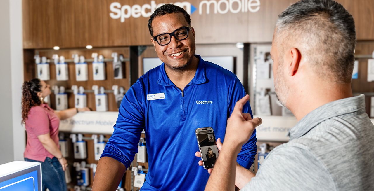 Spectrum Stores employee assists a deaf customer