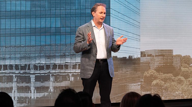 Charter President and CEO Chris Winfrey speaking on stage during an event