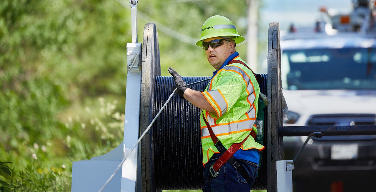 A Spectrum field technician working on a broadband expansion project 