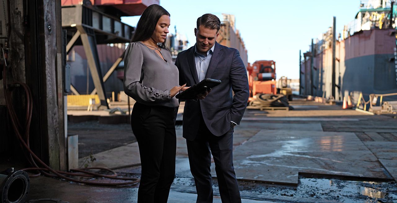 A business man and woman standing at a pier in New York