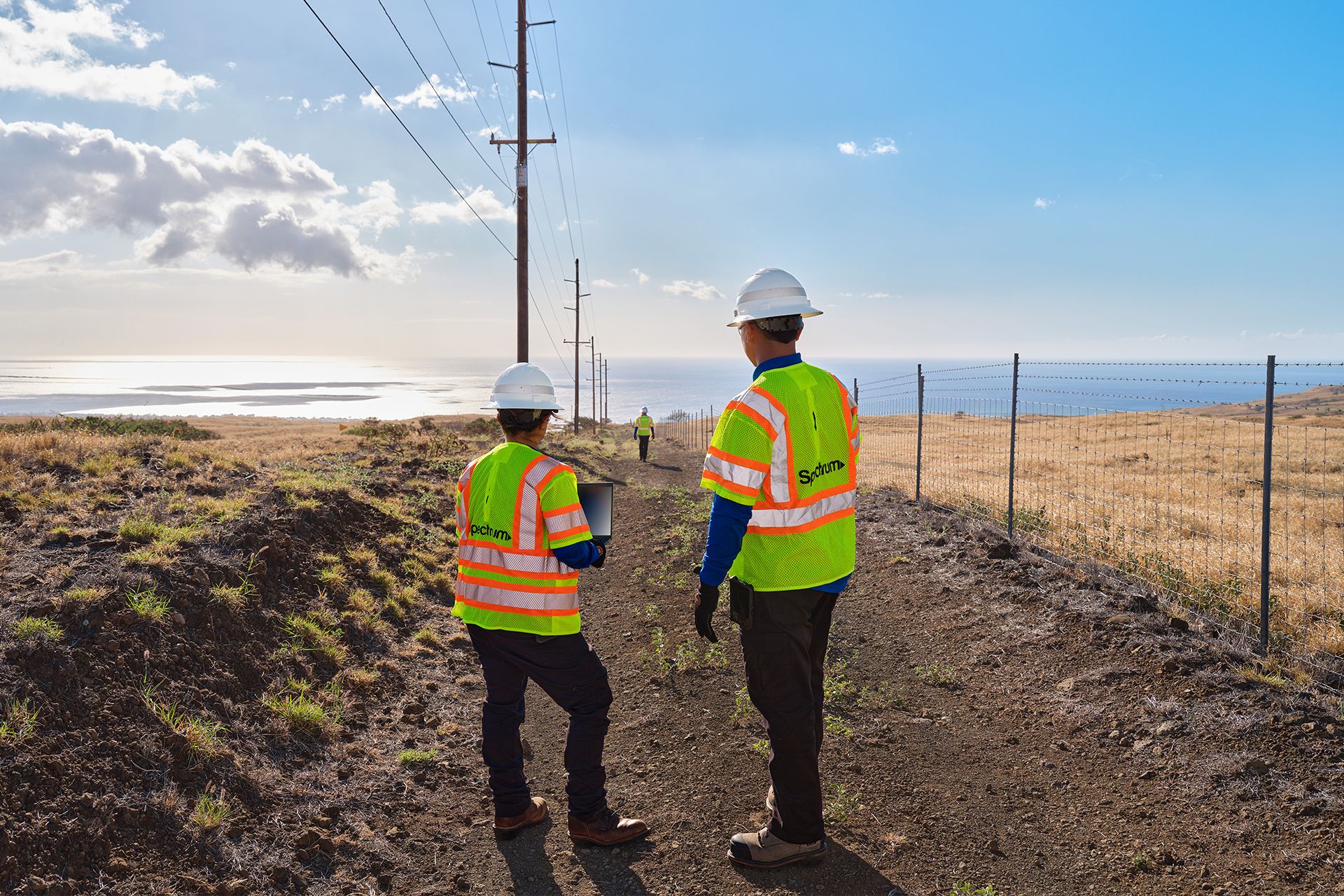 A pair of Spectrum field technicians surveying an area for broadband expansion
