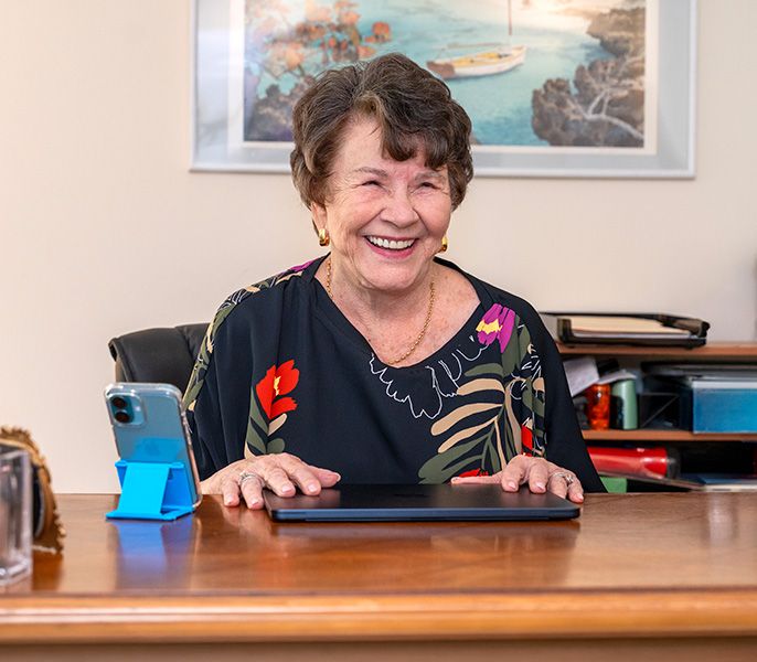 A senior using a tablet, smiling