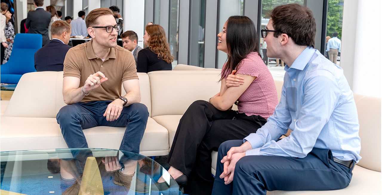 Spectrum interns sitting and talking in a Charter corporate office