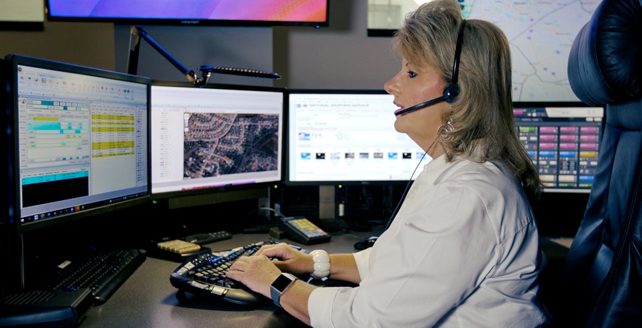 A female 911 operator at her work station
