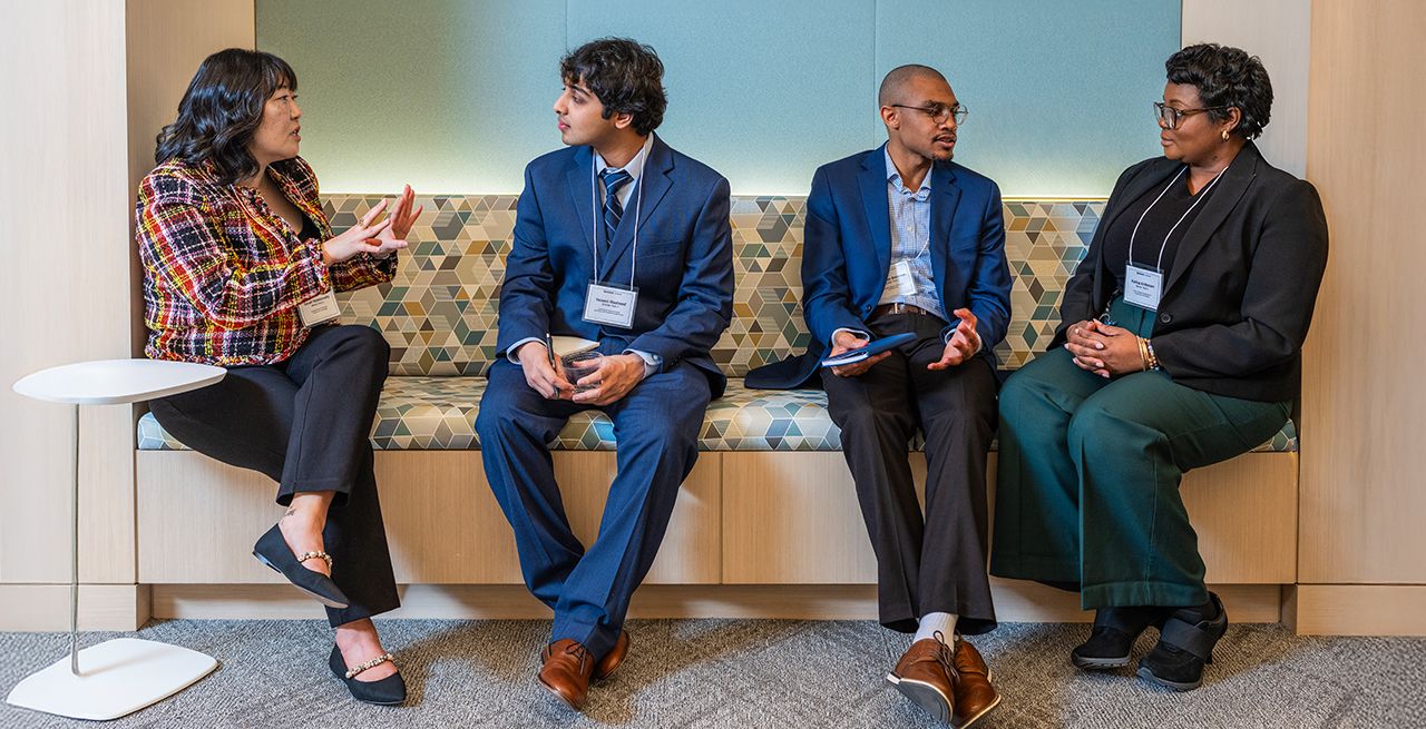 Four Spectrum Scholars sitting in a common area 