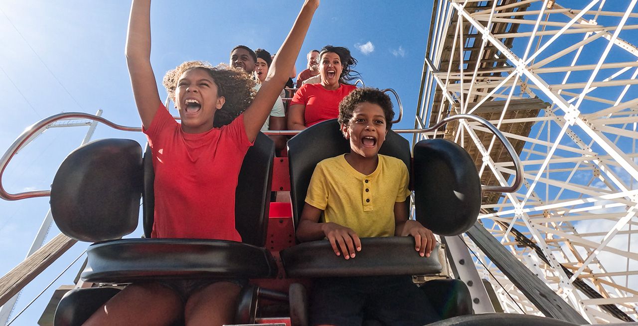 Families enjoying a rollercoaster ride at a Fun Spot America amusement park 