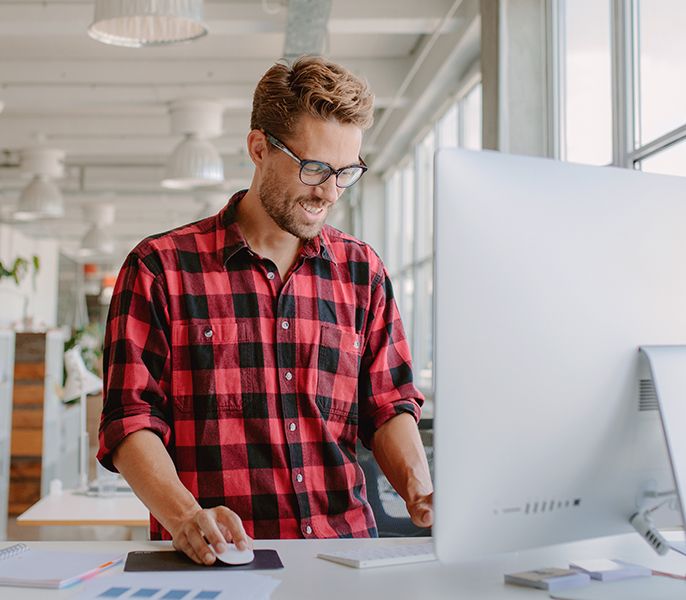 Man working on desktop computer in his place of business