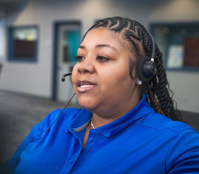 A Spectrum call center rep with headset on assisting a customer