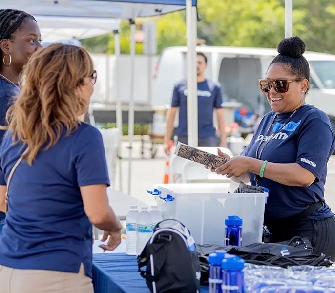 Spectrum Community Impact volunteers working at an event