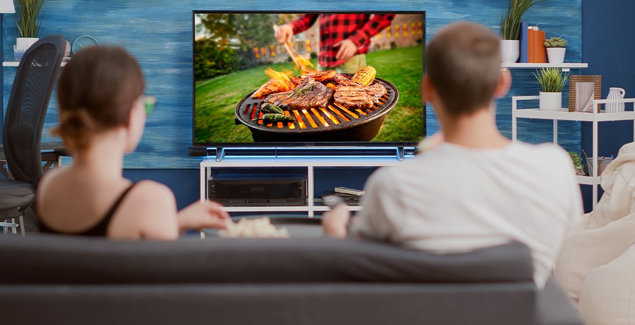Two people watching a television ad in their living room