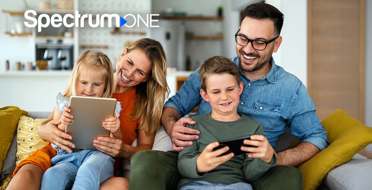 A family using their devices on their couch