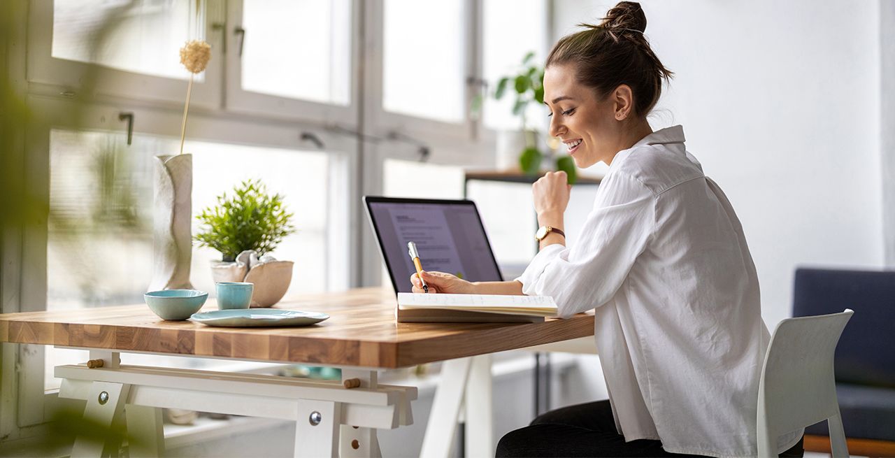 Woman working on her laptop in her home 