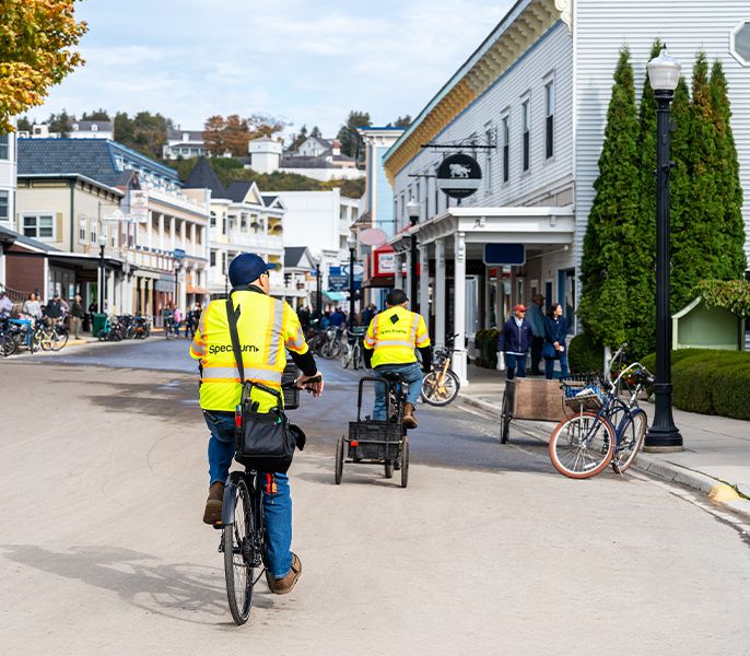 Spectrum field technicians ride bicycles on Mackinac Island