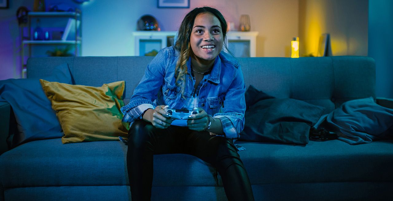 A gamer on her couch with controller