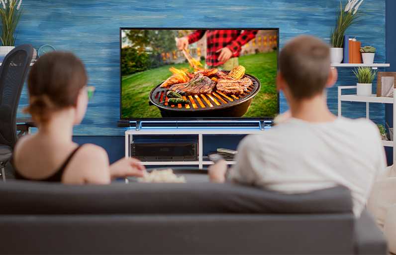Two people watching a television ad in their living room