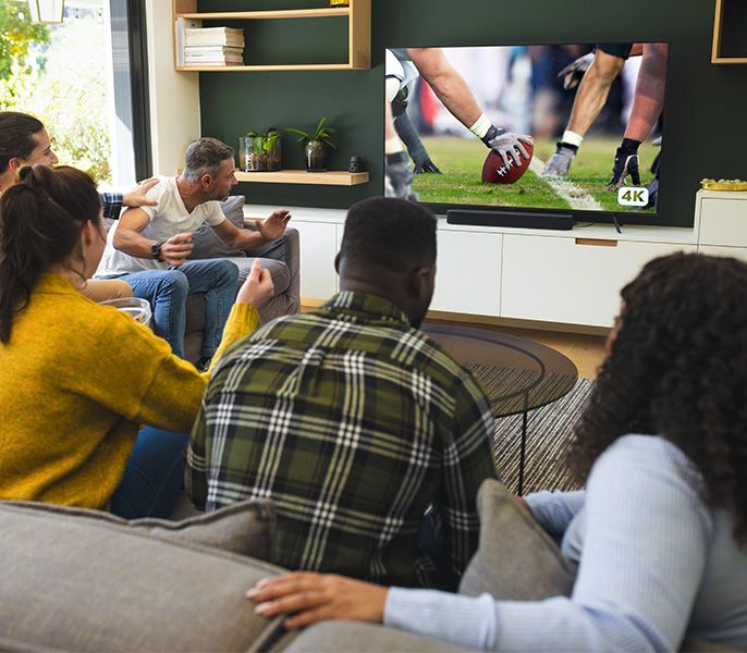 People watching sports programming in a living room