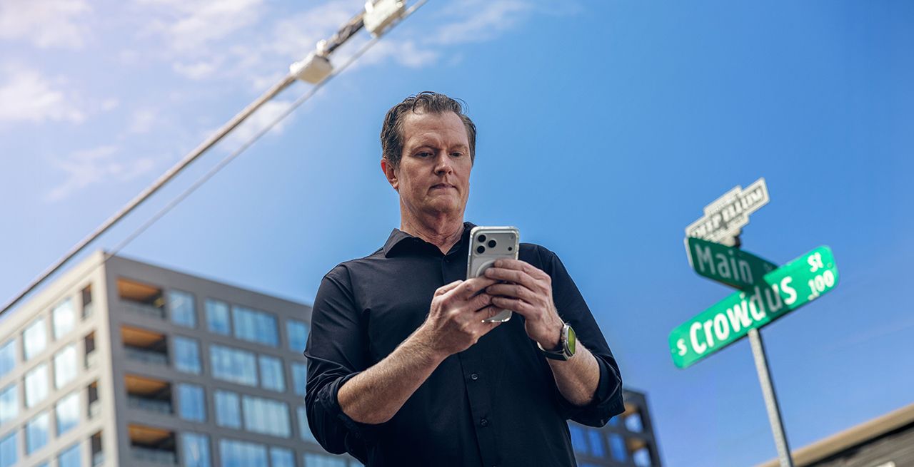 Someone using their smartphone to connect to aerial WiFi