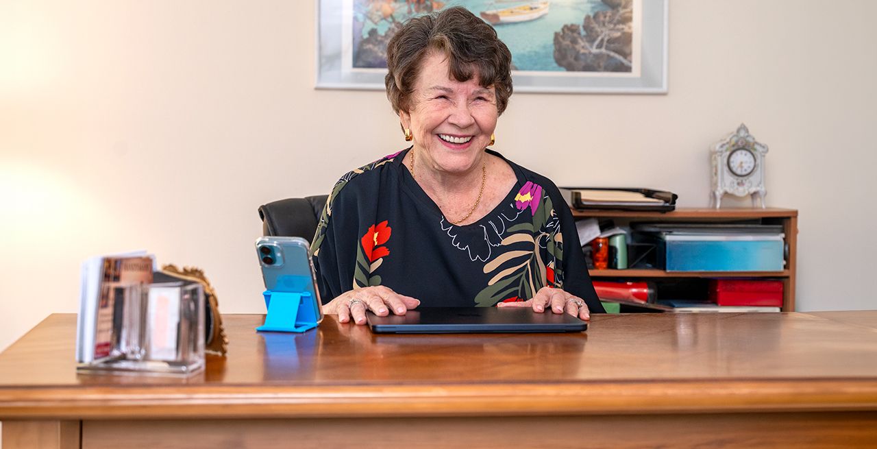 A senior using a tablet, smiling